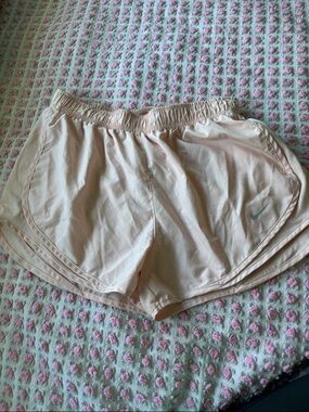 Nike Women's Light Peachy Pink Athletic Running Shorts with Swoosh